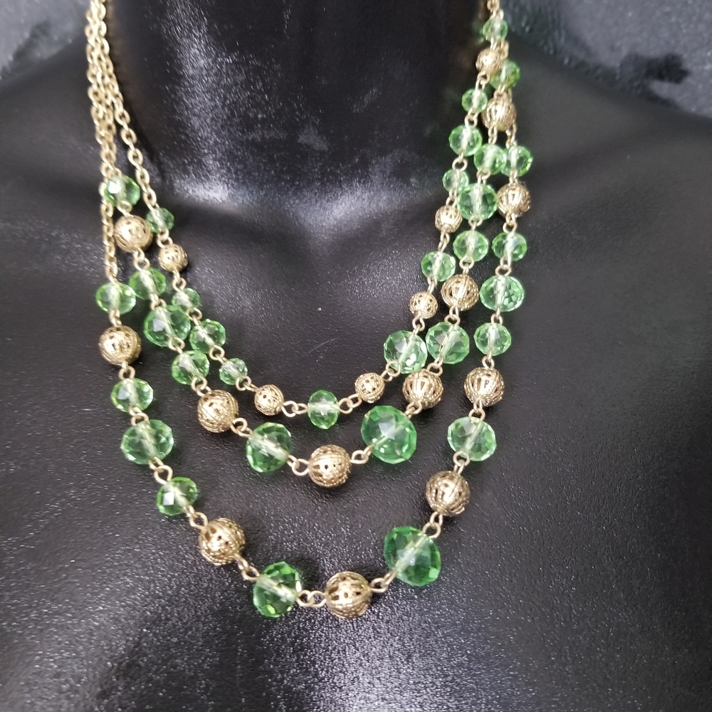 Gold necklace with gold and glass green beads